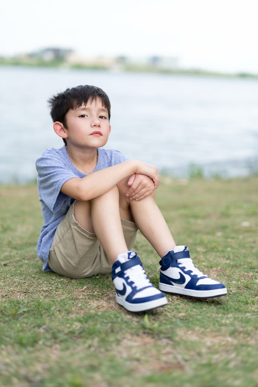 Child portrait seated by the water