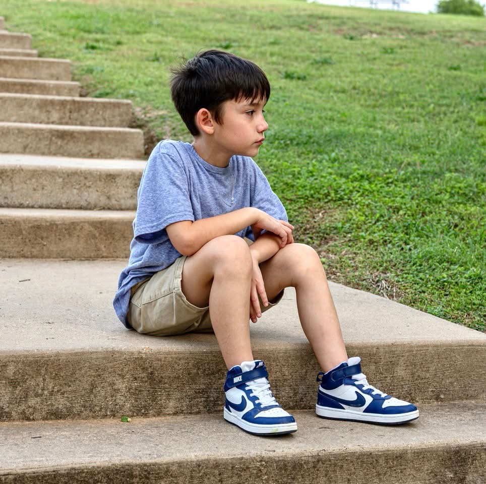 Side profile child portrait on outdoor steps